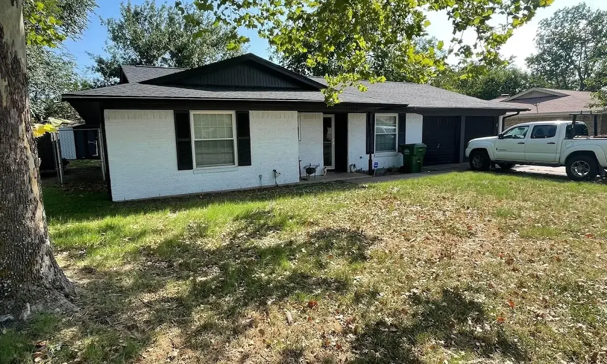 Professional roofing crew working on a residential roof in Moore